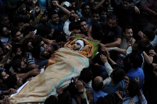 Kashmiri mourners carry the body of Burhan Muzaffar Wani, the new-age poster boy for the rebel movement in the restive Himalayan state of Jammu and Kashmir, ahead of his funeral in Tral, his native town, 42kms south of Srinagar on July 9, 2016. A top commander from the largest rebel group in Indian-administered Kashmir was killed in a gun battle with government forces on July 8, police said. Young and media savvy, Burhan Wani was a top figure in Hizbul Mujahideen and had a one million rupee ($14,900) bounty on his head. Wani, 22, joined the rebel movement at the age of 15 and in recent years had been behind a huge recruitment drive to the group's ranks, attracting young and educated Kashmiris to the decades-old fight for independence of the restive disputed region. Viewed locally as a hero, his death sparked protests in nearby Anantnag town, with hundreds taking to the streets shouting independence slogans and lauding Wani as a revolutionary, witnesses said. / AFP PHOTO / TAUSEEF MUSTAFA
